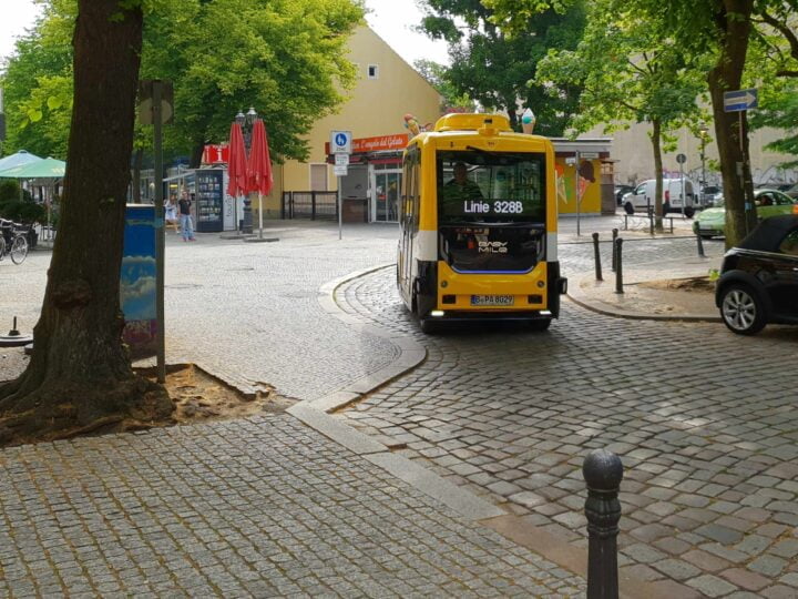 Shuttle in tight curve on one-way street and cobblestones
