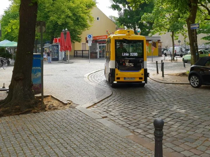 Shuttle in tight curve on one-way street and cobblestones